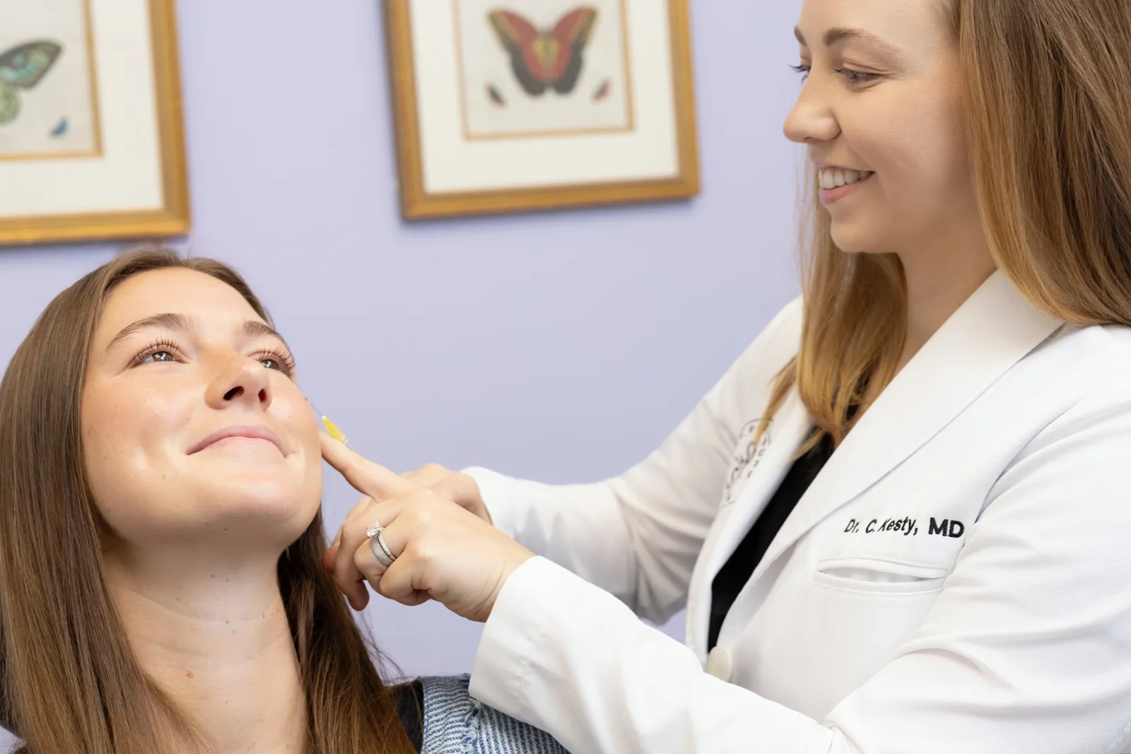 Dr. Chelsea Kesty evaluating facial pigmentation before a Picosecond Laser Facial