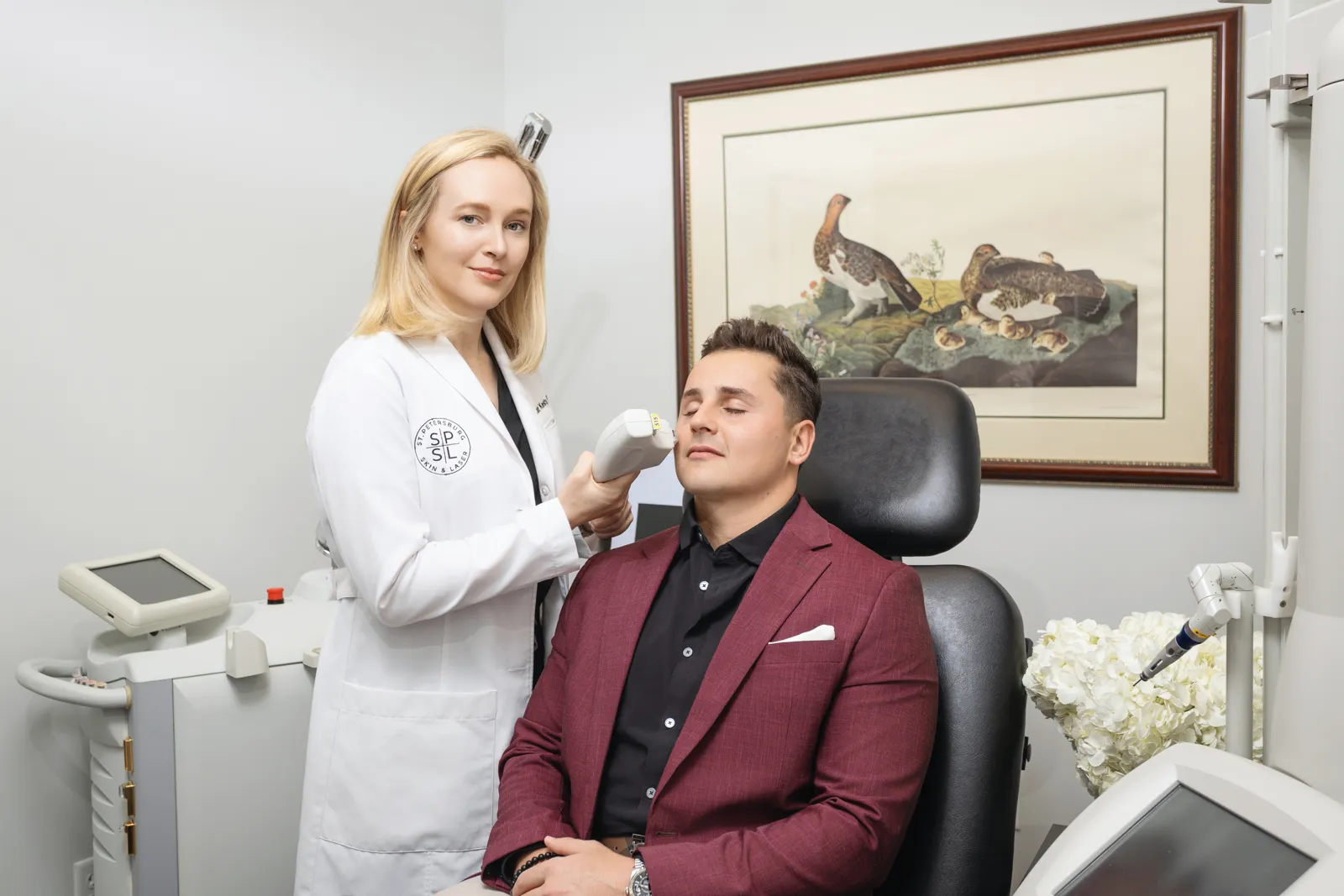 Dr. Kat Kesty performing a Laser treatment with a handheld device