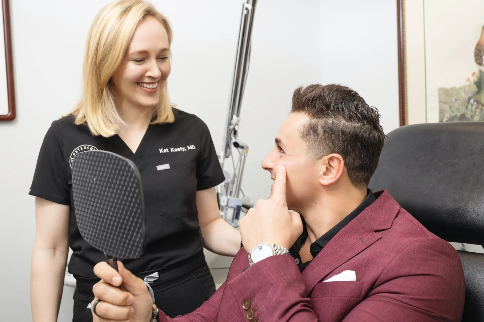 Dr. Kat Kesty reviewing a tattoo removal plan with a patient